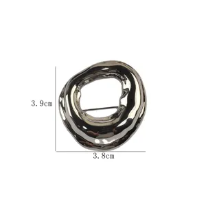Detail view of irregular silver geometric brooch with 3.9cm by 3.8cm dimension markings