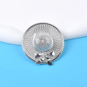 Detailed macro view of a silver straw hat brooch with intricate woven texture and bow