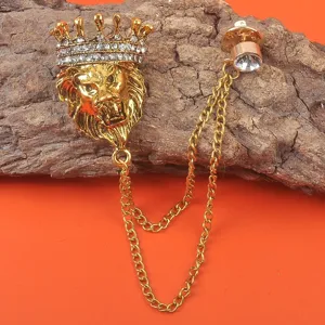 Detailansicht einer goldenen Löwenkopf-Brosche mit Strass-Krone und eleganter Kettenverzierung