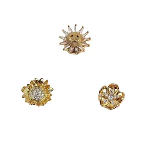 Set van drie elegante magnetische bloembruches met zonnebloem- en lachende zon-motief.