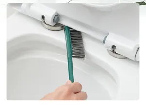 Detailed view of the narrow gap cleaning brush designed for deep toilet edge cleaning.