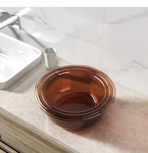 Detailed view of brown translucent plastic washbasin on marble countertop for bathroom use.
