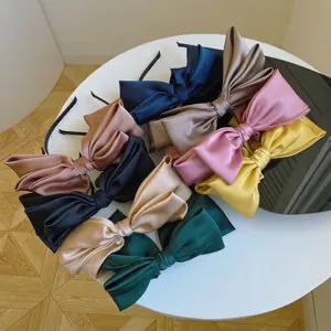 Large satin bow headbands in various colors for elegant high skull top styling