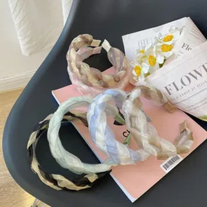 Detailed view of multi-colored braided mesh headbands with non-slip tooth hair hoop design