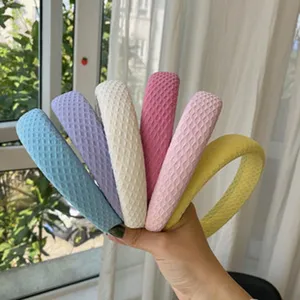 Waffle texture sponge headbands in various pastel colors shown in detail outdoors