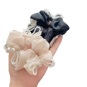 Elegant set of two pearl bow scrunchies in black and champagne colors for women