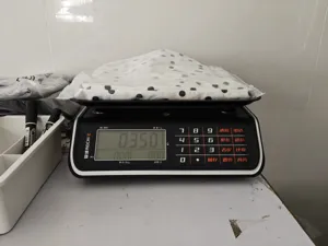 Detailed view of the packaged polka dot halter dress showing product weight and packaging quality.