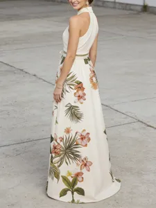 Close-up view of the elegant tropical floral print maxi dress featuring a chic halter neck.