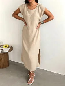 Detail view of the solid beige sleeveless midi dress featuring a side slit and relaxed fit.