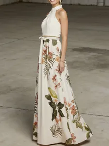 Detailed view of the elegant tropical floral print halter maxi dress with a waist tie bow.