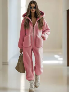Pink plush hooded jumpsuit for women, cozy winter fleece one-piece loungewear with pockets.