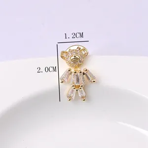 Detailed view of a bear-shaped brooch with sparkling rhinestones and dimension markings