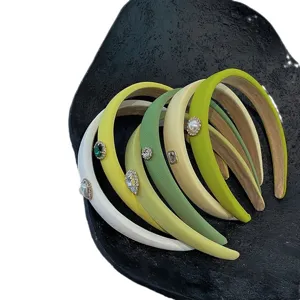 Collection of elegant green padded headbands with crystal and pearl heart charms.