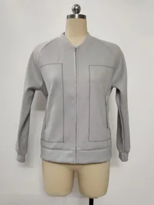 Close up detail of grey imitation wool women jacket showing collar zipper and stitching.