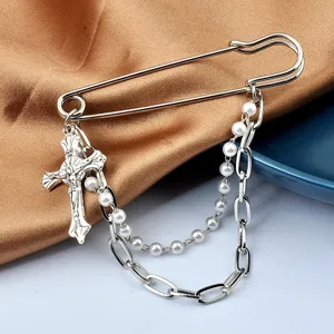 Punk style safety pin brooch with crucifix charm, pearl chain and link chain detail