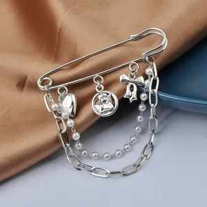 Detailed view of silver safety pin brooch with cherub charms and pearl chain decor