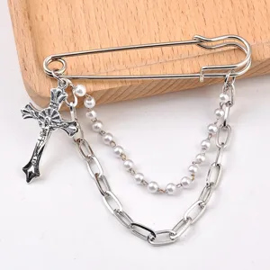 Silver safety pin brooch with crucifix pendant and pearl link double chain detail