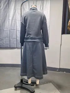 Back view detail of the loose knit top and flared long skirt set in stylish grey blue.