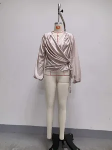 Satin wrap V-neck top detail shot, showing long lantern sleeves and side tie on mannequin.