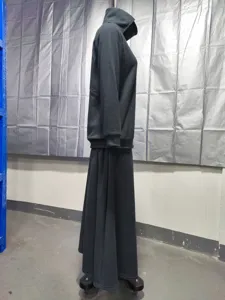 Detail view of dark grey fleece two-piece outfit, showing the hoodie and long skirt texture.