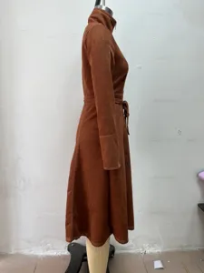 Detailed side view of brown suede zip-up long dress with waist belt and elegant lapel.