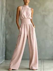 Close-up detail of the sleeveless mock neck and pleated high waist design on the chic jumpsuit.