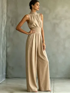Sleeveless high-neck solid color wide-leg jumpsuit, elegant summer casual long pants detail.