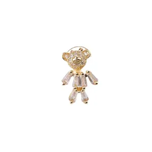 Cute gold-toned teddy bear brooch with sparkling clear baguette crystals