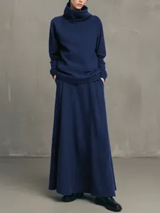 Minimalist solid color turtleneck sweatshirt and maxi skirt two-piece set in deep blue.