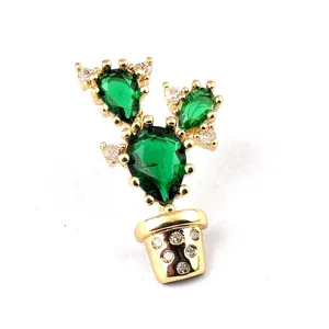 Detailed close-up of a gold-plated cactus brooch featuring pear-shaped green crystals