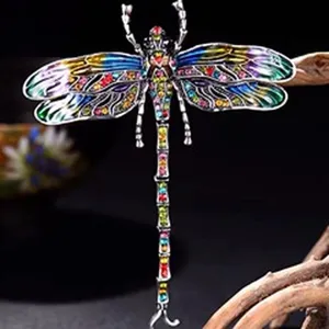 Detailed close-up of a vibrant multi-color rhinestone dragonfly brooch accessory