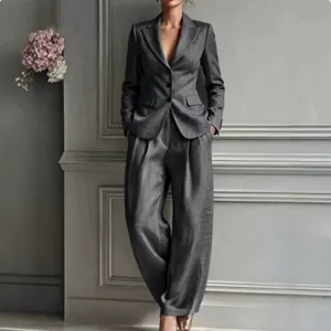 Detailed view of women's casual gray suit jacket and loose wide-leg trousers two-piece set.
