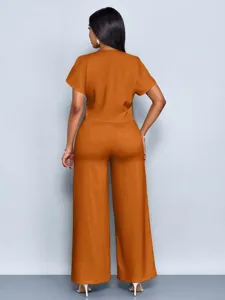 Back view of women casual two piece set featuring solid orange short sleeve top and wide leg pants.