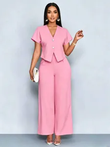 Pink two-piece set detail view, showing the short-sleeve V-neck top and wide-leg trousers.