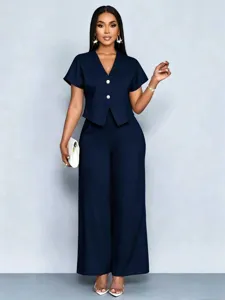 Close-up details of the dark navy blue short sleeve V-neck top and wide leg pants set.