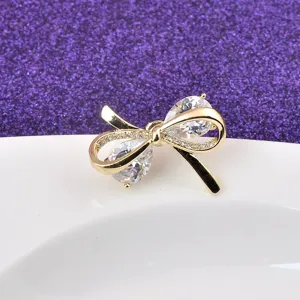 Elegante goudkleurige strikbros met schitterende zirkonia voor dameskleding
