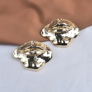 Detailed close-up of a vintage golden lips brooch with rhinestone embellishments