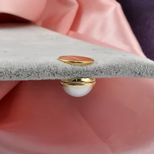 Detailed side view of magnetic pearl anti-exposure buckle on fabric