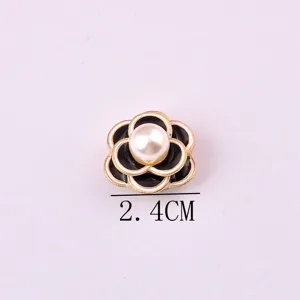 Macro detail of a black camellia magnetic brooch with pearl center measuring 2.4cm