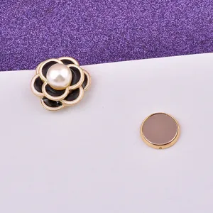 Close-up of a elegant magnetic camellia brooch featuring a pearl center and metal disc backing