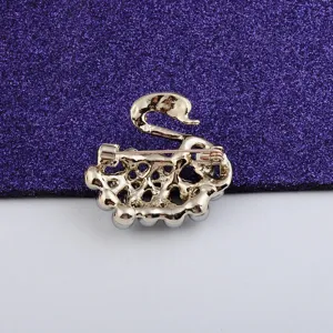 Detailed back view of a gold-plated swan brooch featuring silver pearls and pin