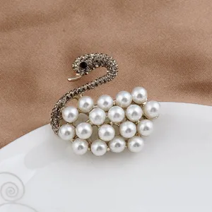 Detailed view of an elegant swan brooch with pearls and sparkling grey rhinestones