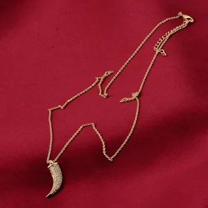 Detailed view of 18K gold plated horn pendant with fine micro-pave cubic zirconia
