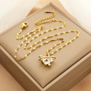 Collar de acero de titanio dorado con colgante de corazón y planeta con circonitas.