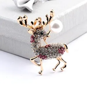 Detailed view of reindeer brooch with white pearl and glittering rhinestones