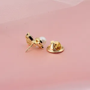 Detailaufnahme der goldenen Hasen-Brosche mit Perle und Schmetterlingsverschluss