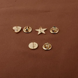 Close-up detail of gold-plated geometric lapel pins featuring secure butterfly clutch backings