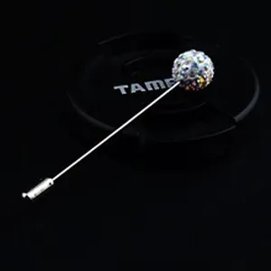 Macro detail of a silver-toned lapel pin with a sparkling multicolor rhinestone ball.