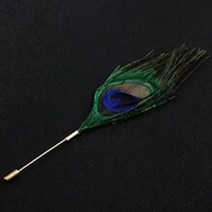 Detailed view of an elegant peacock feather brooch with a golden lapel pin