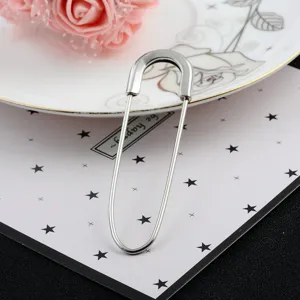Close-up detail of a large silver safety pin brooch for cardigans and scarves.
